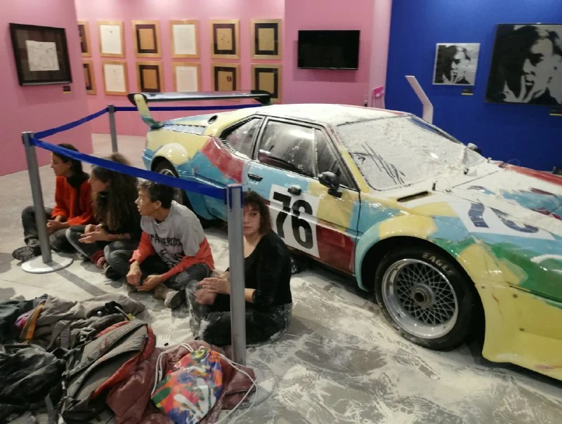 Climate activists throw flour at a BMW art car painted by Andy Warhol in 1979 at Fabbrica del Vapore in Milan, Italy.