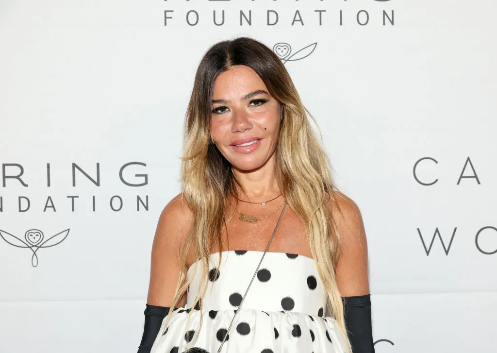 Smiling woman on a red carpet.