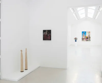 Installation view of a white-cube gallery with a skylight, showing a sculpture and painting in one room and a sculpture and painting in a back room. 