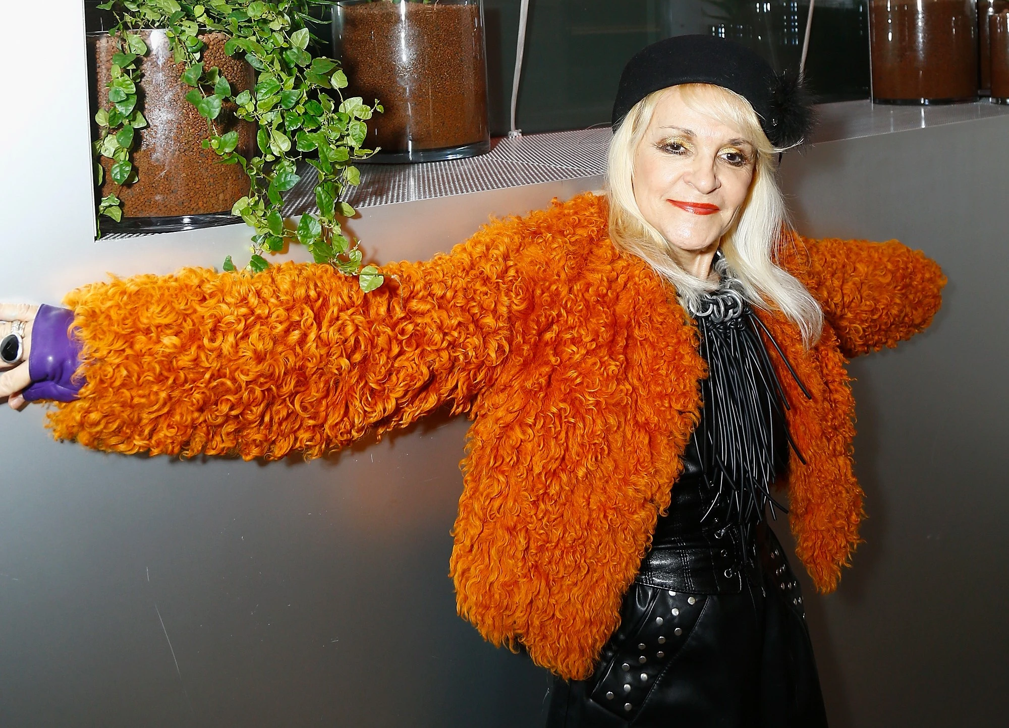 Gallerist Suzanne Tarasieve attends the Lafayette Anticipations Cocktail Party on March 5, 2018 in Paris, France. She is wearing a bright orange coat, a black beret, red lipstick, and a Black frilled shirt. She died on December 27, 2022 at age 73.