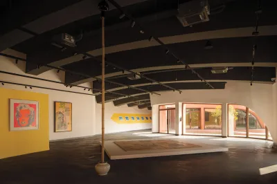 View of an art exhibition with several artworks on view including a Warhol Marilyn.
