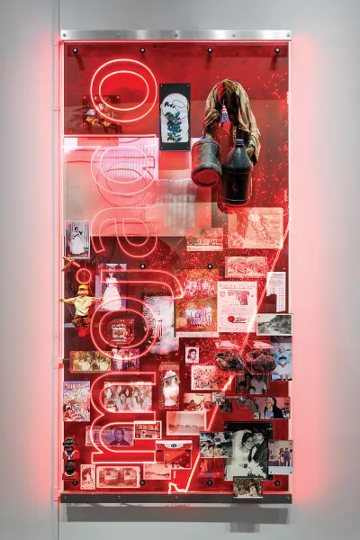 A wall-hung mixed-media work that features the word 
