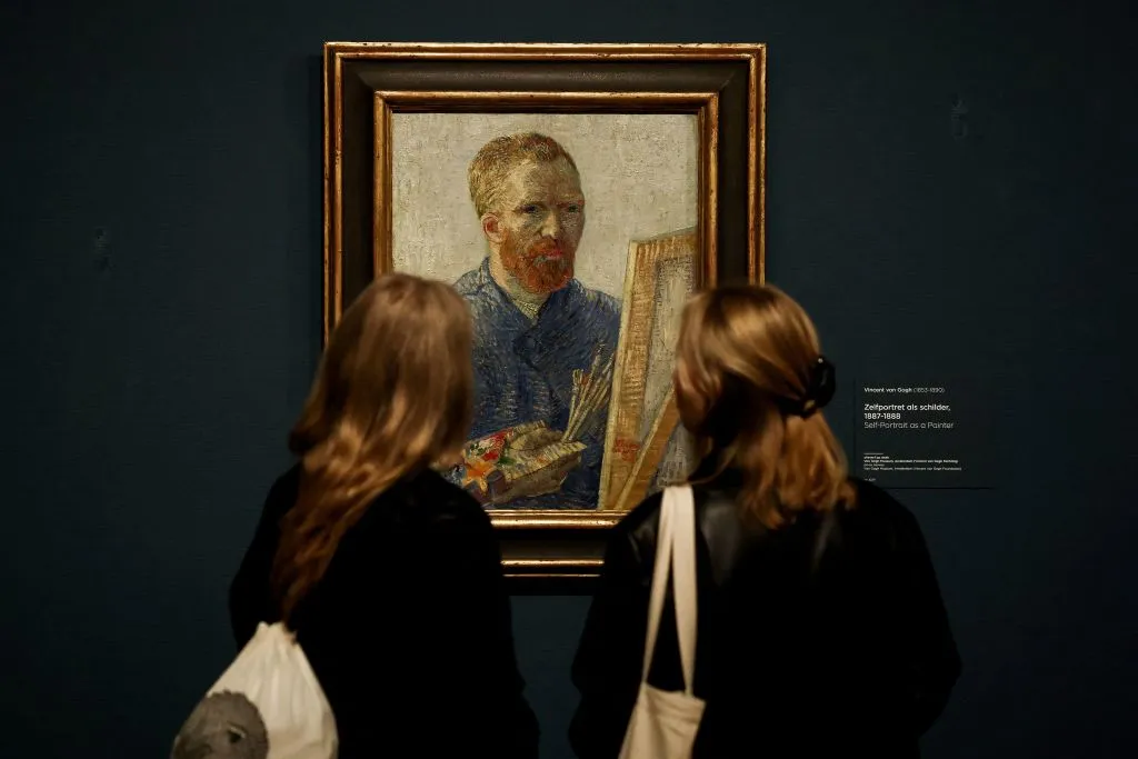 Visitors look at a selfportrait of Vincent Van Gogh at the Van Gogh Museum