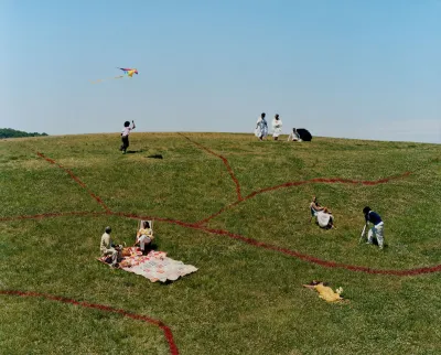 A photograph showing various Black people on a green lawn with red lines drawn on the grass.