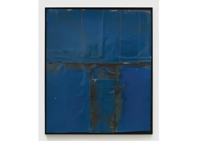 An artwork that resembles a painting but is made from pieces of blue metal.