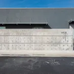View of the exterior of an industrial building with the street number 14105 on it.