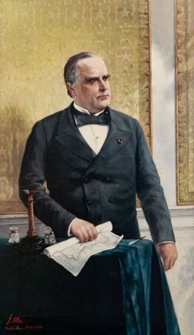 A painting showing William McKinley standing at a table holding a map of Puerto Rico.