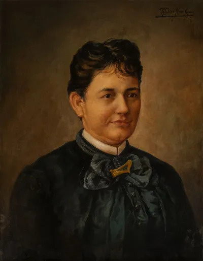 A portrait of a woman who looks regal and has short hair and is more masculine presenting.
