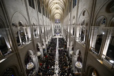 TOPSHOT - Members of the clergy leave after the consecration of the new main altar, designed by French artist and designer Guillaume Bardet which replaces the old one that was destroyed in 2019, after a mass at the Notre-Dame de Paris cathedral, in Paris on December 8, 2024. Newly restored Notre Dame cathedral is set to hold its first service for the public on December 8, 2024 after a historic re-opening ceremony that saw firefighters, builders and artists celebrated for their work saving the 12th-century masterpiece. The beloved Paris monument nearly burned down in 2019, but has been renovated inside and fitted with a new roof and spire during a frenzied reconstruction effort since then. (Photo by JULIEN DE ROSA / AFP) / RESTRICTED TO EDITORIAL USE - MANDATORY MENTION OF THE ARTIST UPON PUBLICATION - TO ILLUSTRATE THE EVENT AS SPECIFIED IN THE CAPTION (Photo by JULIEN DE ROSA/AFP via Getty Images)