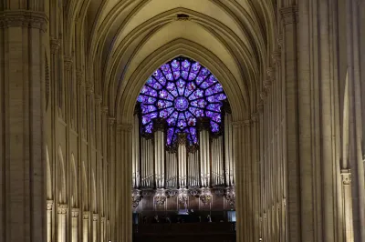 This photograph shows the stained glass Rose Window of the Notre-Dame de Paris Cathedral in Paris during the first mass for the public during its re-opening ceremony, in Paris, on December 8, 2024. Newly restored Notre Dame cathedral is set to hold its first service for the public on December 8, 2024 after a historic re-opening ceremony that saw firefighters, builders and artists celebrated for their work saving the 12th-century masterpiece. The beloved Paris monument nearly burned down in 2019, but has been renovated inside and fitted with a new roof and spire during a frenzied reconstruction effort since then. (Photo by Ludovic MARIN / AFP) (Photo by LUDOVIC MARIN/AFP via Getty Images)