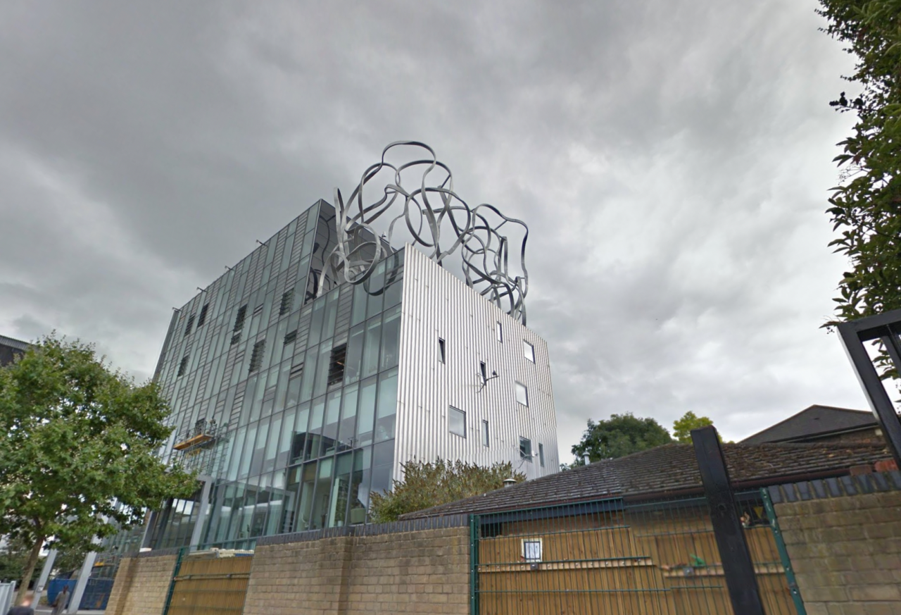 Exterior view of modern building against clouds.