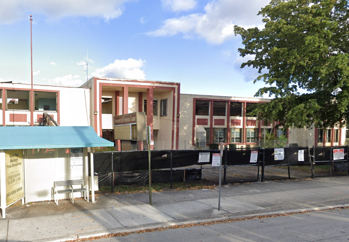 Image of school facade against blue sky.