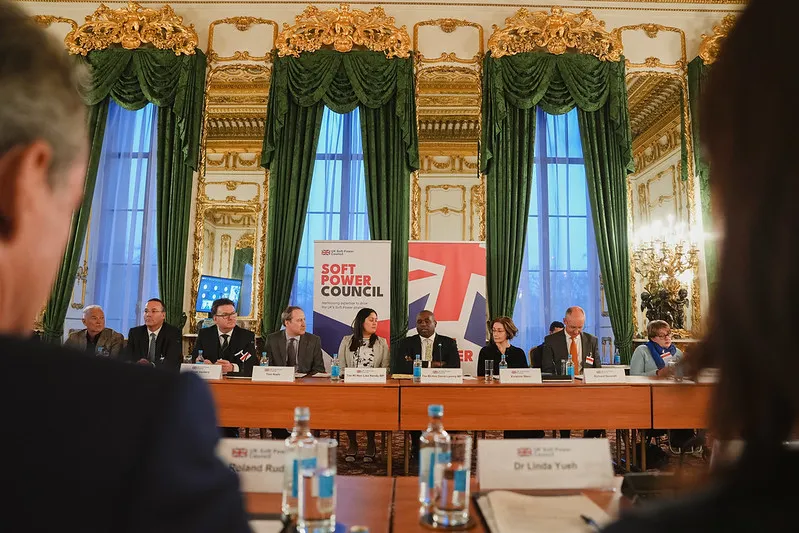 People sit in a row behind a table.