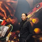 Portrait of Samantha Box in front of one of her artworks.