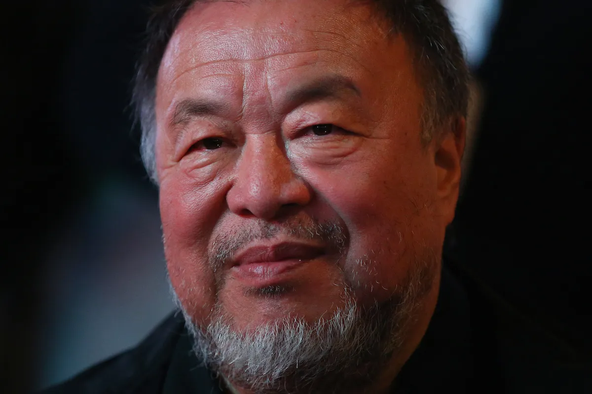 An Asian man smiling.