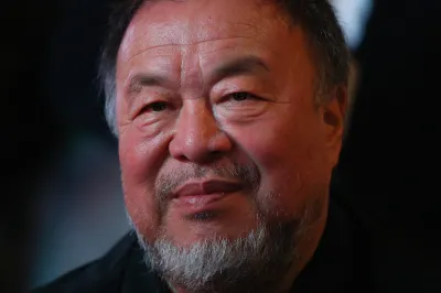 An Asian man smiling.