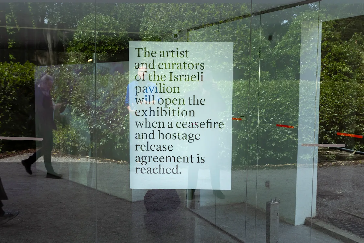 A sign posted to a glass window reading 