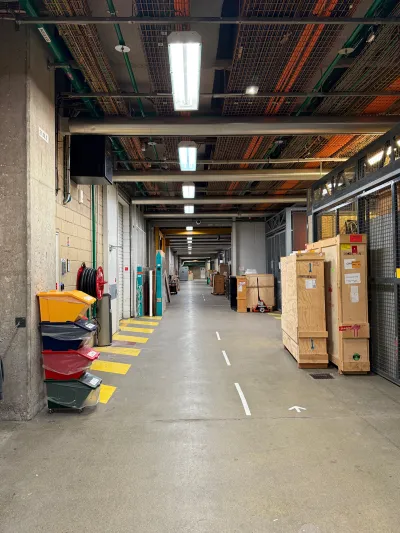 View of an underground storage hallway in a museum with a crate for art seen at right.