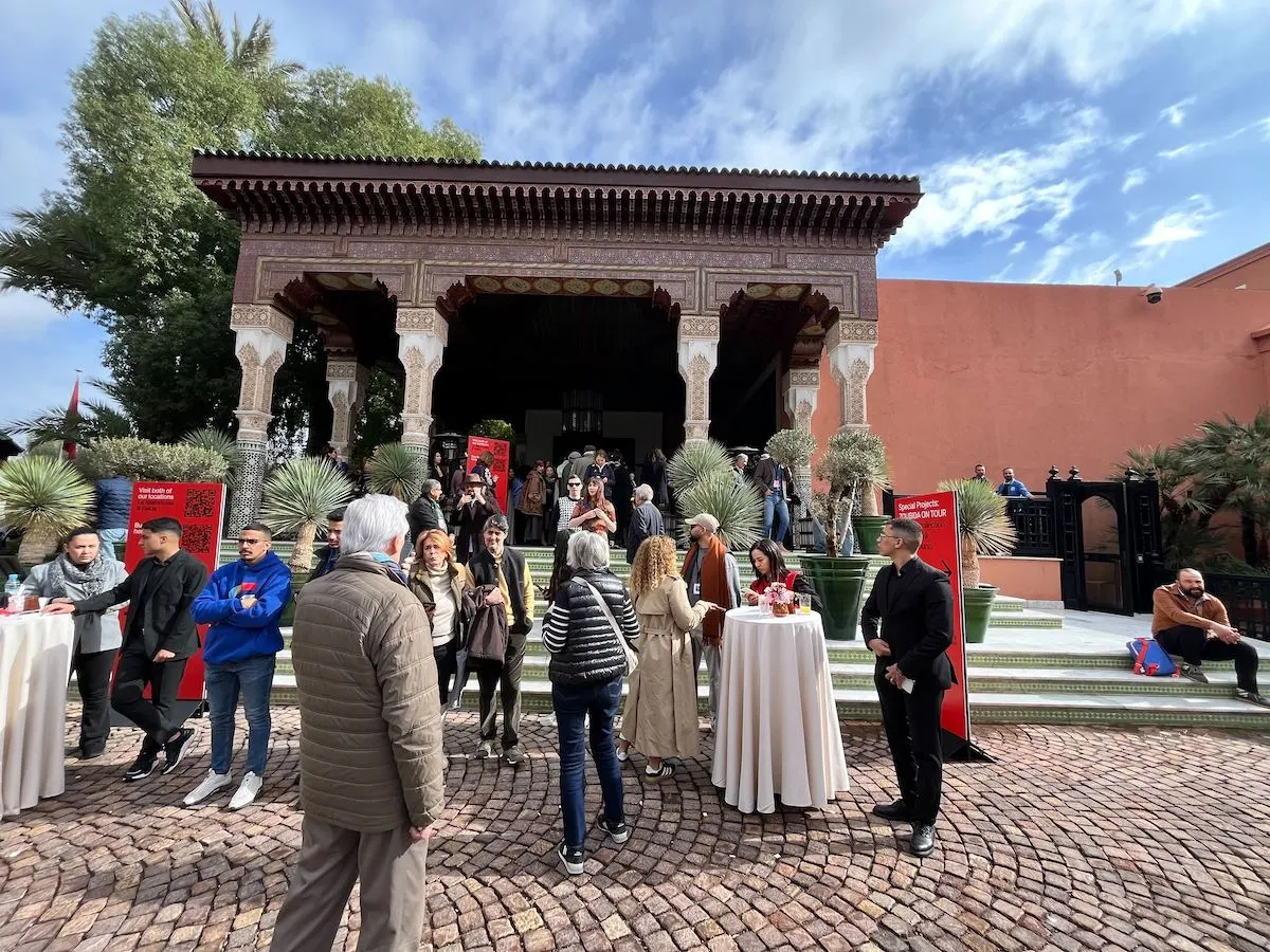 A group of people outside the entrance to a hotel.