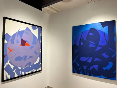 Two abstract paintings resembling calligraphic forms against colorful backgrounds.