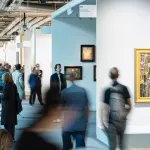 View of a crowded art fair with several people blurred.