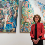 woman in front of painting