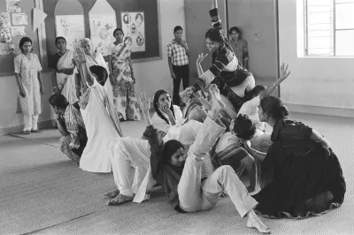 A black-and-white photograph of several woman dancing in a group.