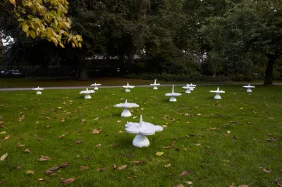 A group of flower-shaped sculptures in a park.