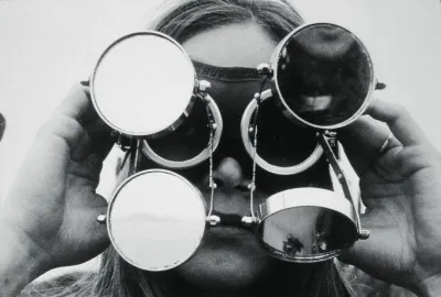 A woman with a glasses-like device strapped to her head.
