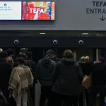 People queue outside an art fair.