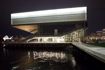 A museum whose top floor hangs out over a nearby harbor.