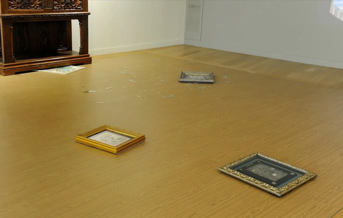 Several artworks on the floor of a gallery.