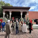 A group of people outside the entrance to a hotel.