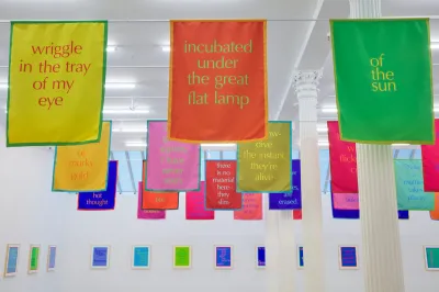 A series of hanging banners featuring sentence fragments.