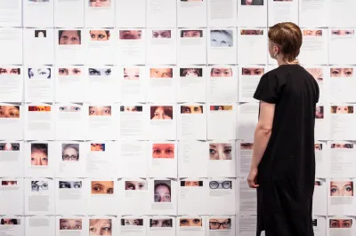 A woman looking at printouts of people