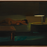 Woman on couch next to light.