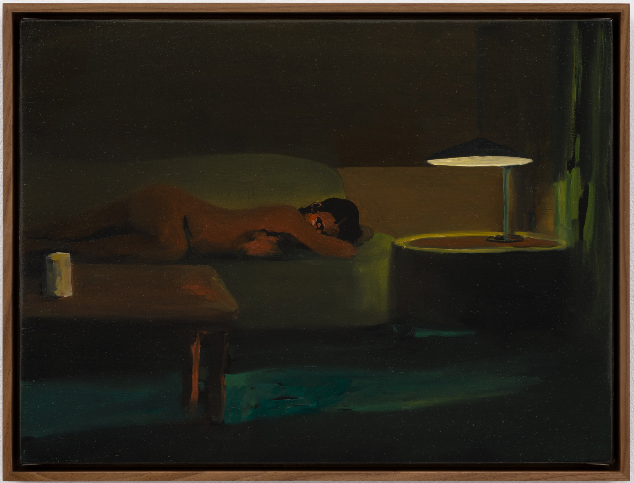 Woman on couch next to light.