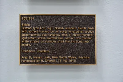 A sculpture resembling a museum wall text cast in bronze.