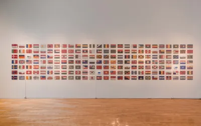 A group of flags remade in colored sand.