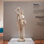 A mable statue at the entrance of "Rediscovered Treasures", a new exhibition at the National Archeological Museum of Naples featuring 600 previously missing Italian artifacts seized or confiscated by a police unit focused on preserving Italy