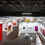Aerial view of an empty art fair with various booths shown.