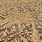 A 3d-rendered image of an arid desert town.
