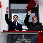 French President Emmanuel Macron and Indian Prime Minister Narendra Modi wave from the balcony during the inauguration of the Indian Consulate as part of a visit in Marseille, France, on February 12, 2025. (Photo by Christian Hartmann / POOL / AFP) (Photo by CHRISTIAN HARTMANN/POOL/AFP via Getty Images)
