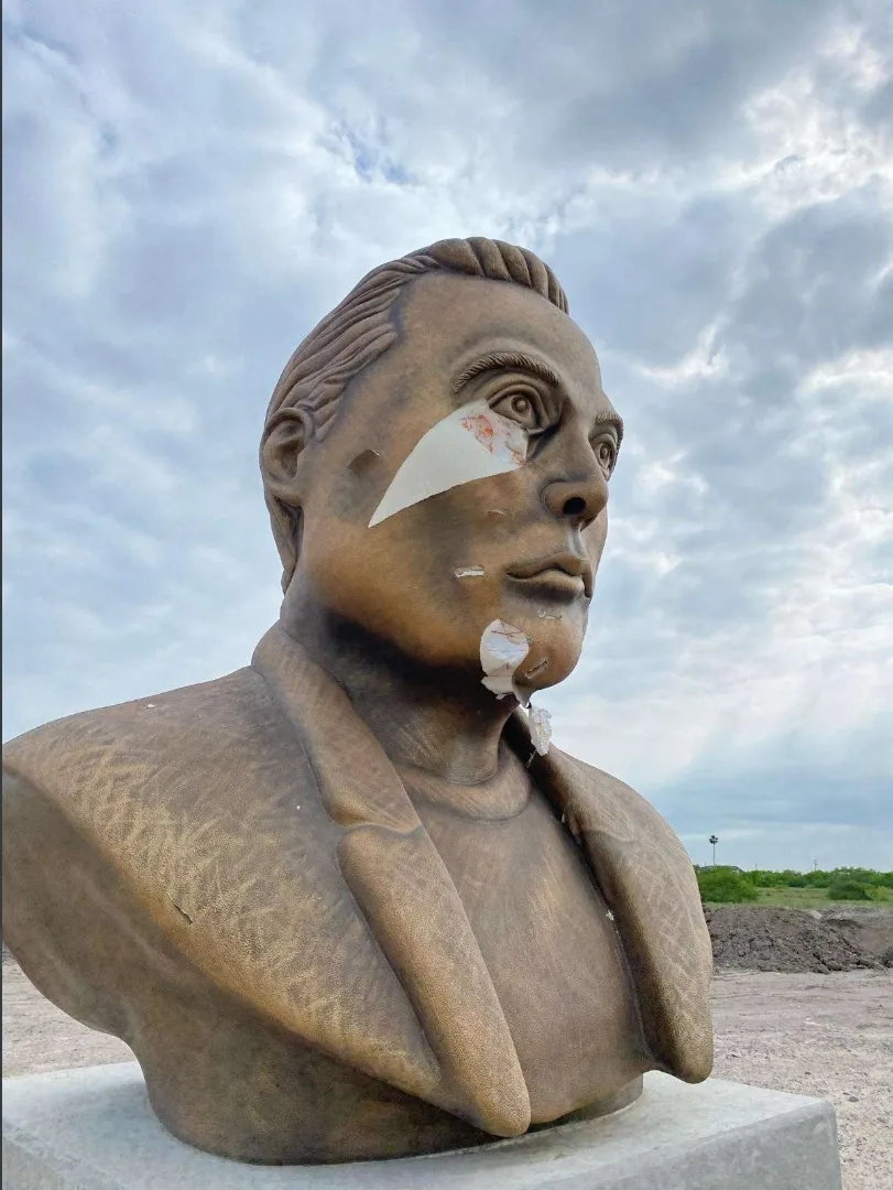 A gouged bust of a middle-aged white man.