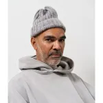Portrait of Daniel Boyd, wearing a gray beanie and grey hoodie.