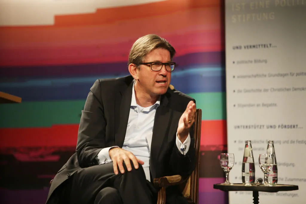 A man in glasses and a suit.