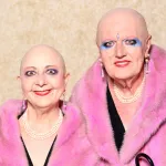 Two bald people in pink mink coats.