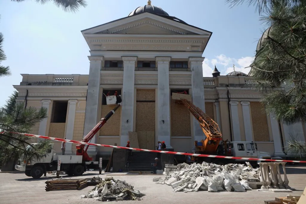 TOPSHOT - Cranes and workers board up the windows of the Transfiguration Cathedral damaged as a result of a missile strike in Odesa on July 23, prior to a service on July 24, 2023, amid the Russian invasion of Ukraine. Ukraine on Sunday said 19 people, including four children, were wounded in a Russian overnight missile attack on Odesa that also killed one person. (Photo by Oleksandr GIMANOV / AFP) (Photo by OLEKSANDR GIMANOV/AFP via Getty Images)