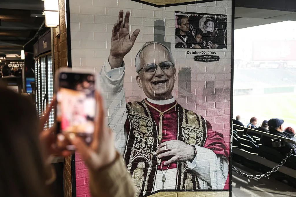 CHICAGO, ILLINOIS - MAY 20: Fans take pictures of the mural of Pope Leo XIV during a rain delay in the game between the Seattle Mariners and Chicago White Sox at Rate Field on May 20, 2025 in Chicago, Illinois. (Photo by Geoff Stellfox/Getty Images)