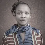 A gray-scale image featuring a woman in a striped shirt.